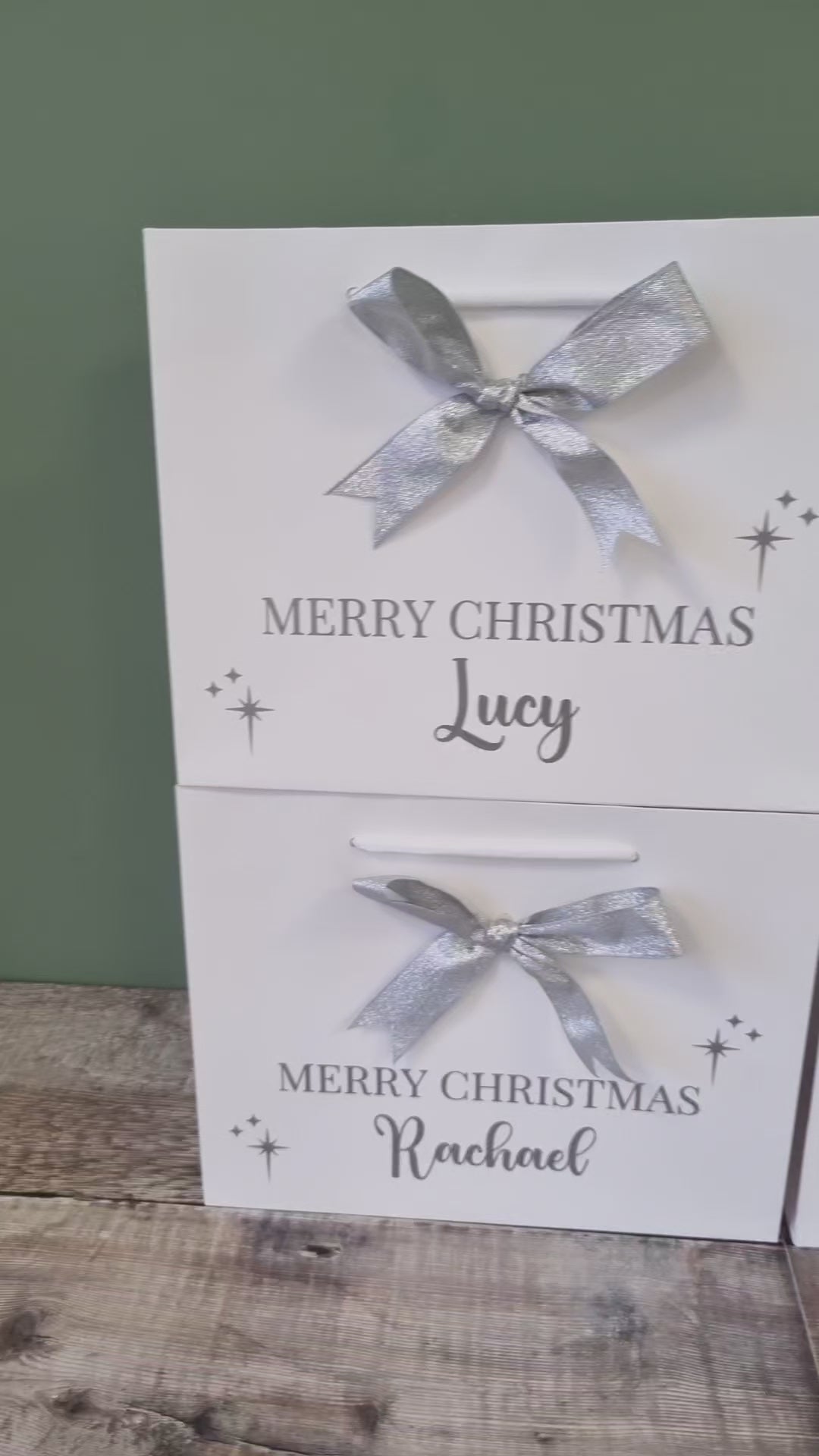 Personalised gift bag in white with silver  writing and matching silver bow. 
