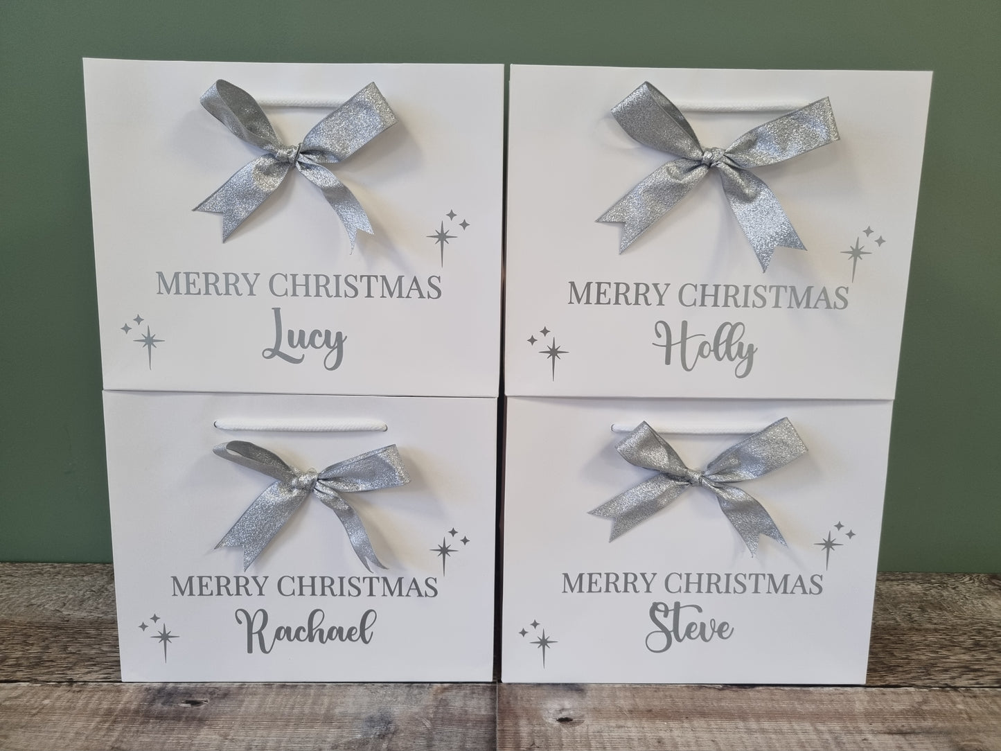 Personalised gift bag in white with silver writing and matching silver  bow. 